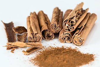 Cinnamon Sticks and Ground Powder on White Background