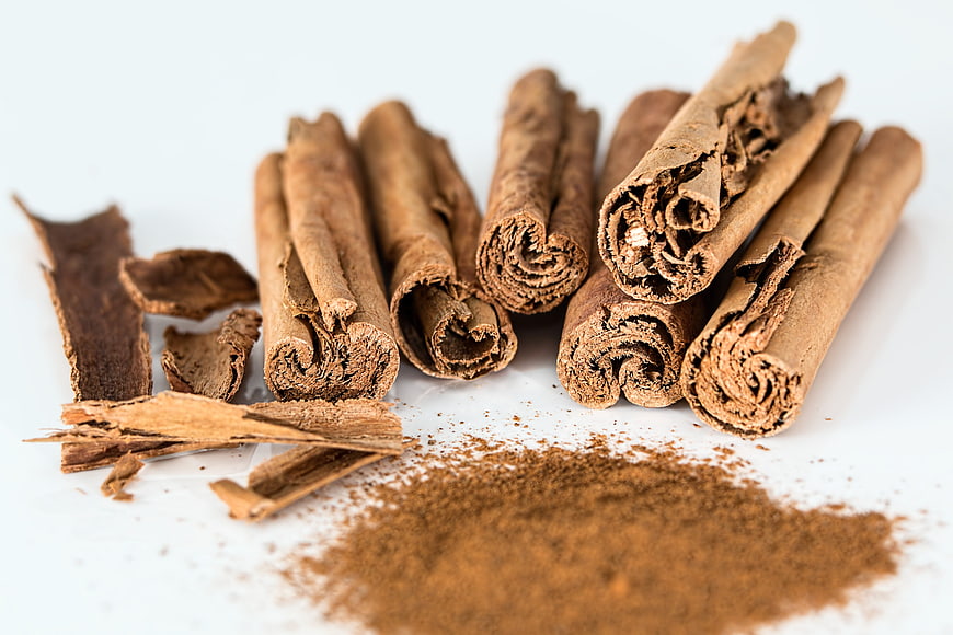 Cinnamon Sticks and Ground Powder on White Background