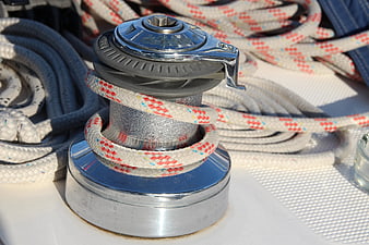 Close-up of chrome boat winch with coiled rope