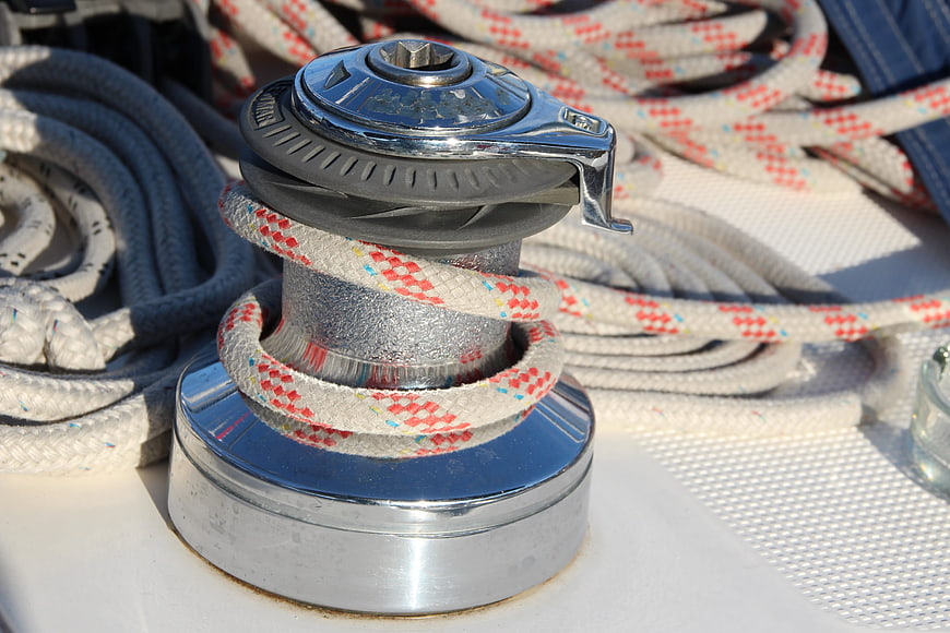 Close-up of chrome boat winch with coiled rope