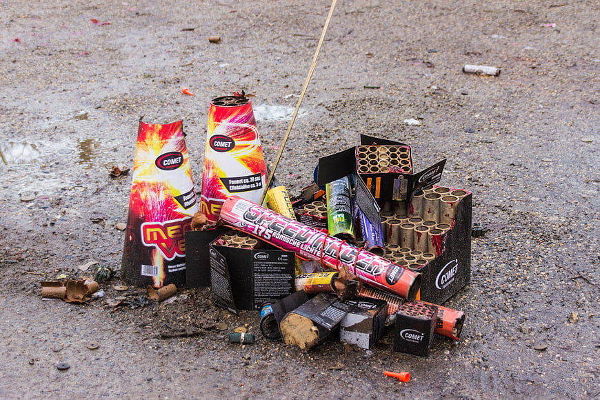 Used Fireworks and Firecracker Waste on Wet Asphalt Ground