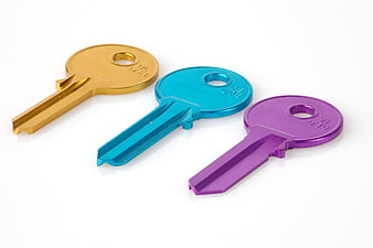 Three Colorful Metal Keys on White Background