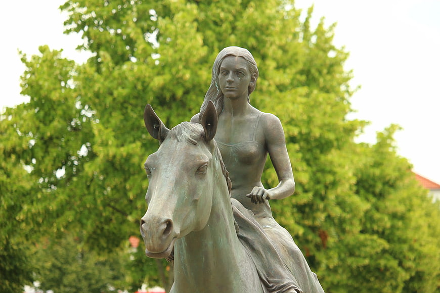 Bronze Statue of Woman Riding Horse in Park