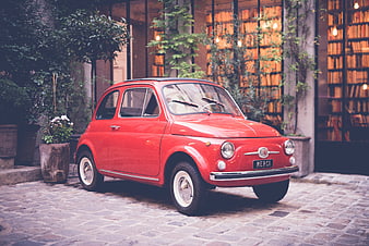 Vintage Red Fiat 500 Parked on Cobblestone Street
