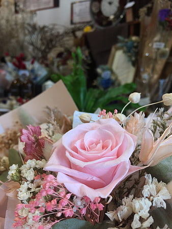Close-up of a pink rose in a dried flower bouquet