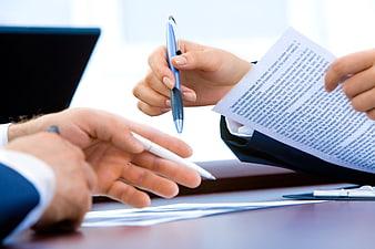 Business hands signing contract with pen in office