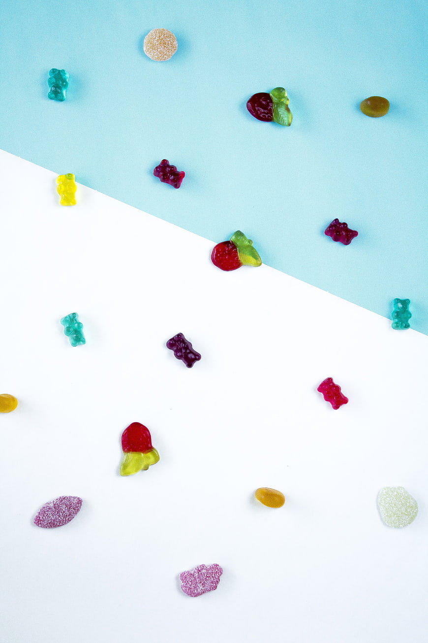 Colorful Gummy Bears and Candies on Split Background