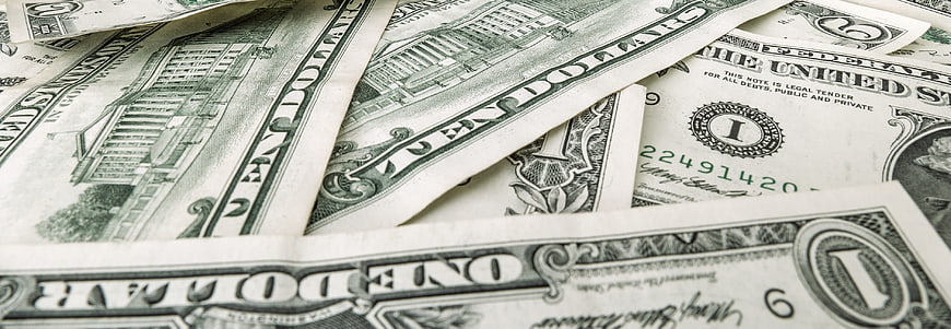 Close-up of scattered US one dollar bills