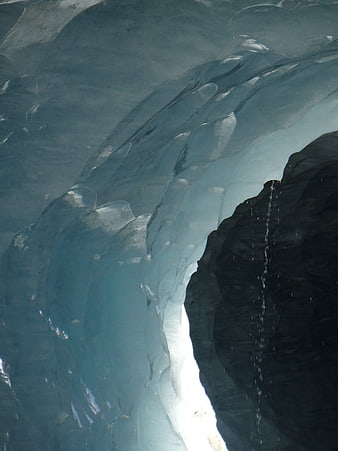 Close-up of blue glacier ice with dripping water