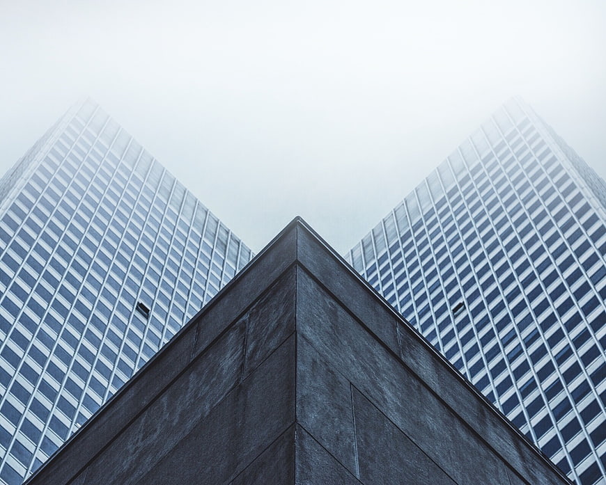 Low angle view of modern skyscrapers in fog