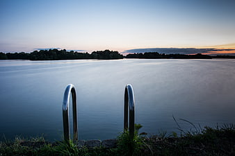 Serene Lake Sunset with Metal Ladder Rungs