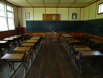 Vintage wooden classroom interior with desks and chalkboard