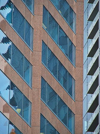 Modern Office Building Facade with Glass Windows and Stone Cladding