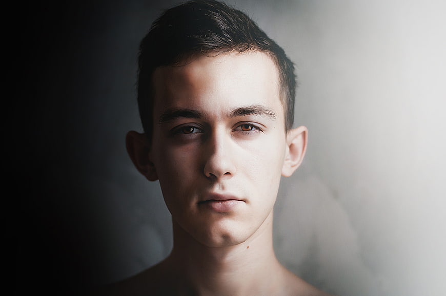 Serious young man portrait with dramatic lighting