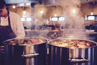 Chef Cooking Steaming Soup in Large Stainless Steel Pots