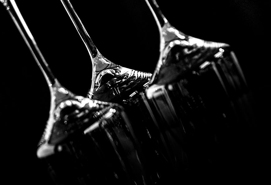 Close-up of three elegant wine glasses on black background