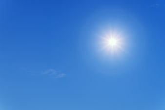 Bright Sun In Clear Blue Sky With Sunburst Rays