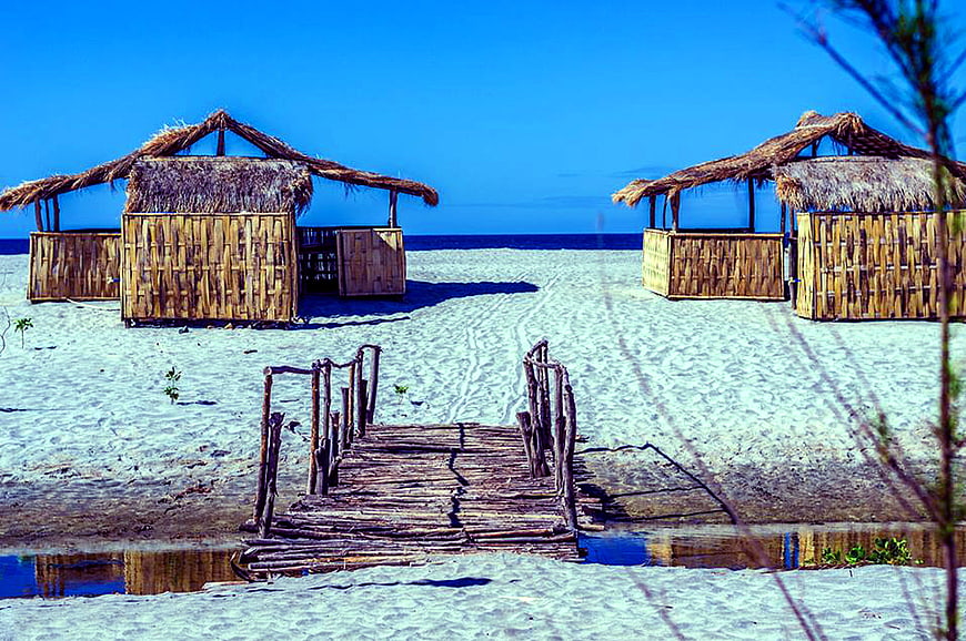 Tropical Beach Huts with Wooden Dock and Blue Sky