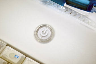 Close-up of white computer power button on laptop