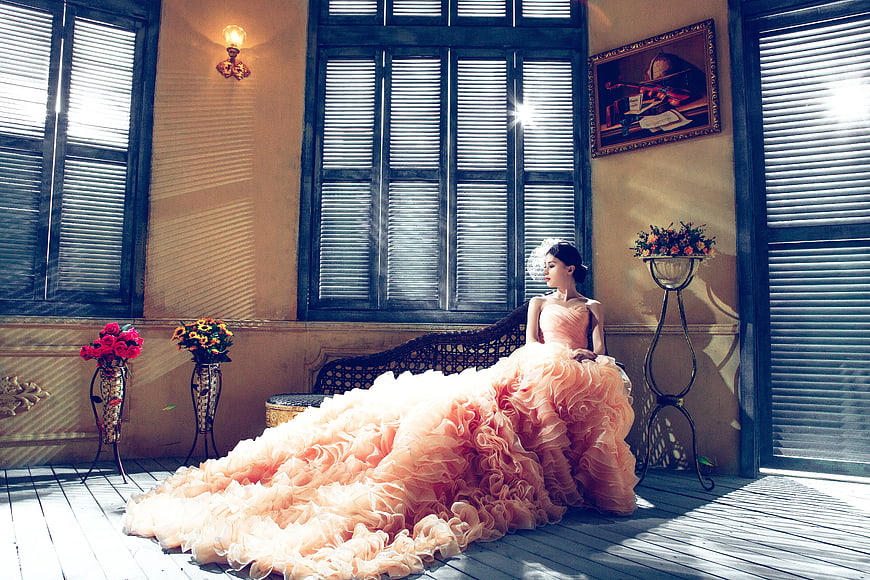 Woman in Peach Ruffled Gown Sitting on Vintage Balcony