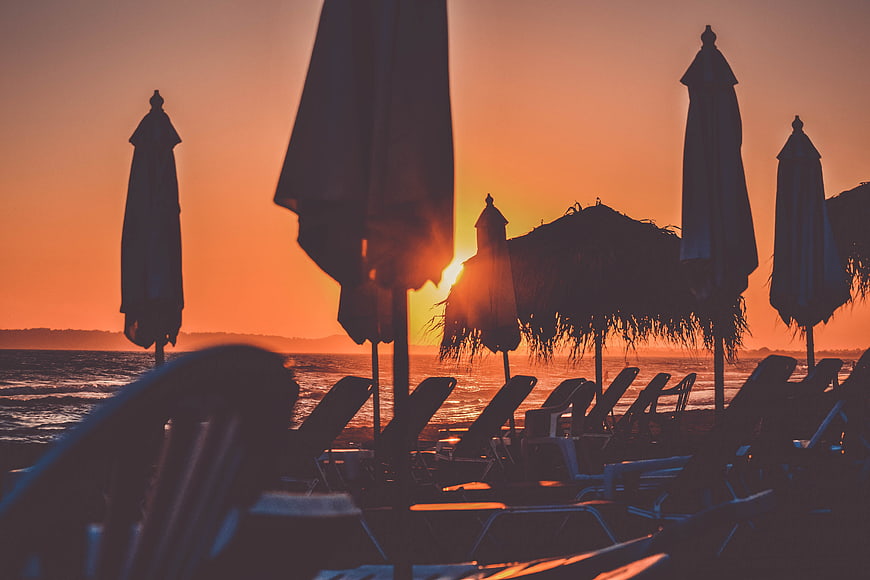Silhouetted Beach Umbrellas and Chairs at Sunset
