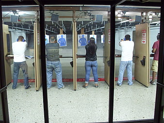 Indoor Shooting Range With Multiple People Practicing Target Shooting
