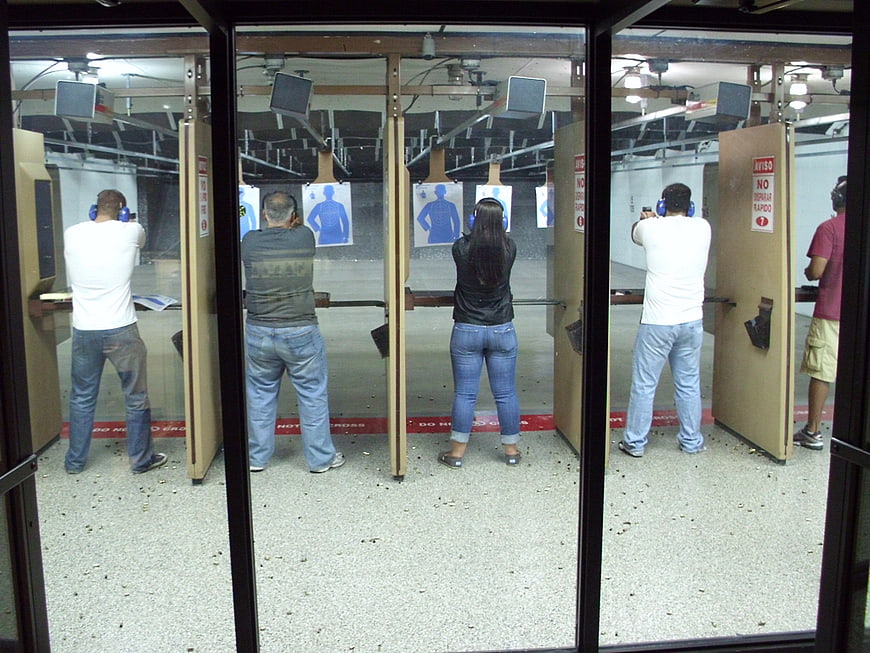 Indoor Shooting Range With Multiple People Practicing Target Shooting