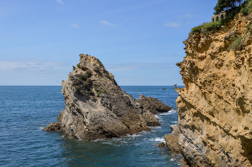 Rugged Coastal Cliffs and Sea Stack in Blue Ocean