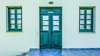 Symmetrical Green Door And Windows On White Building Facade