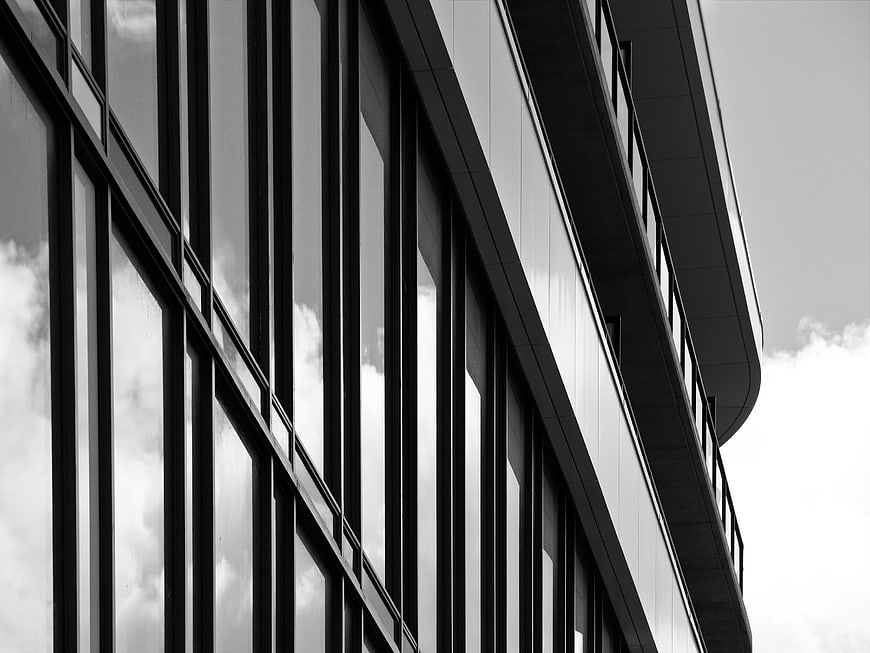 Black and White Modern Office Building Facade with Cloud Reflections