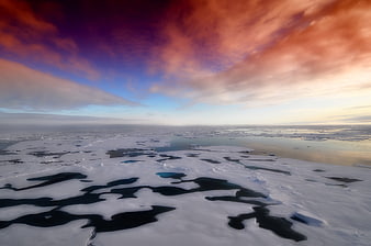 Aerial View of Arctic Sea Ice Under Dramatic Sunset Sky