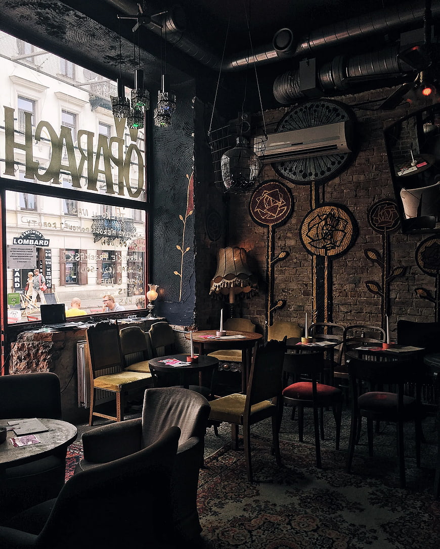 Dark moody interior of a vintage cafe with brick walls