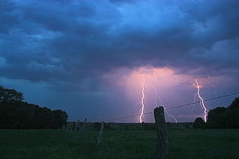 Dramatic Lightning Strike Over Rural Pasture at Dusk