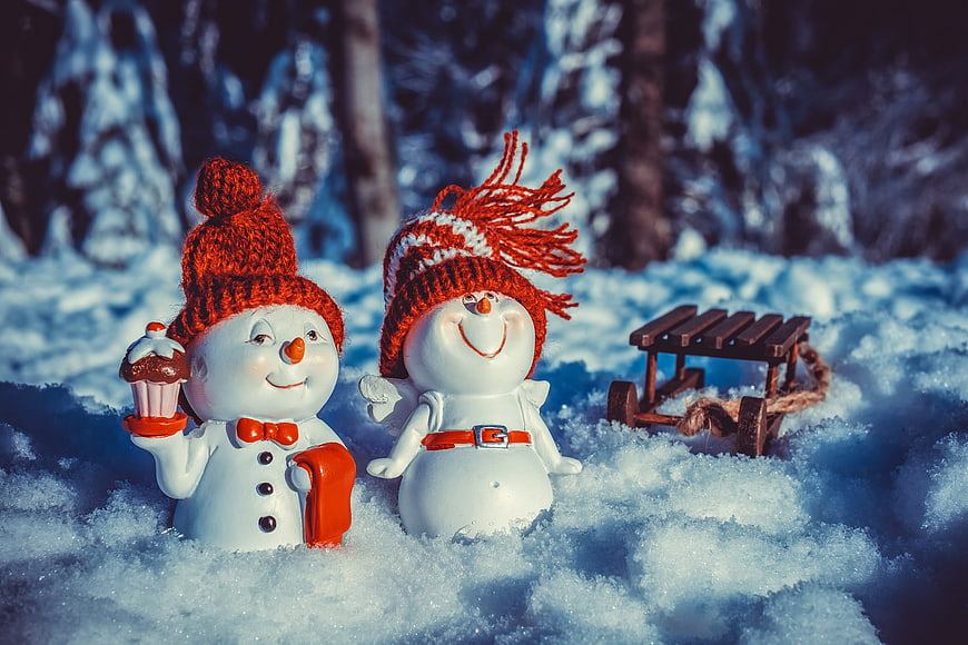 Cute Christmas Snowman Couple Figurines in Snowy Winter Forest