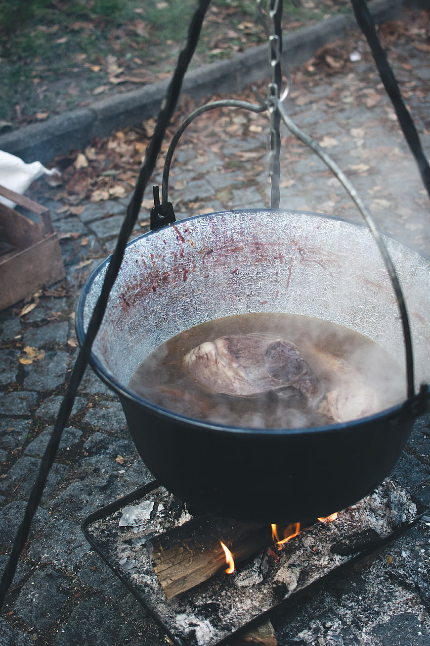 Traditional outdoor cooking with a cauldron over an open fire
