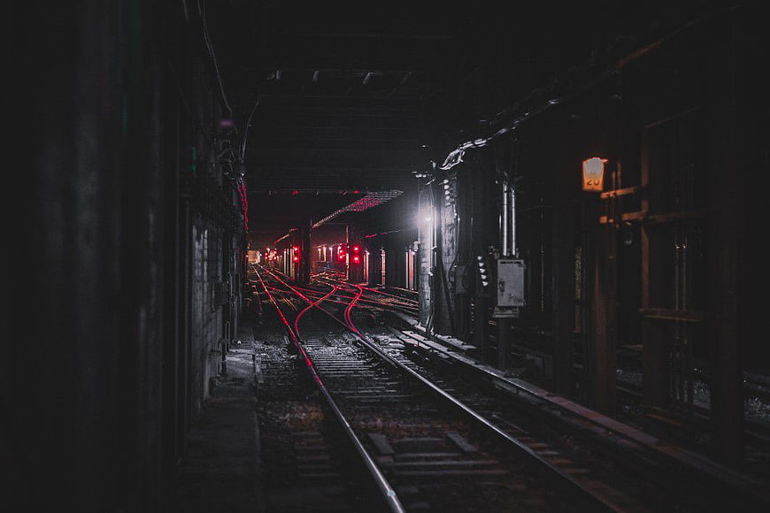 Dark Underground Subway Tunnel with Red Signal Lights