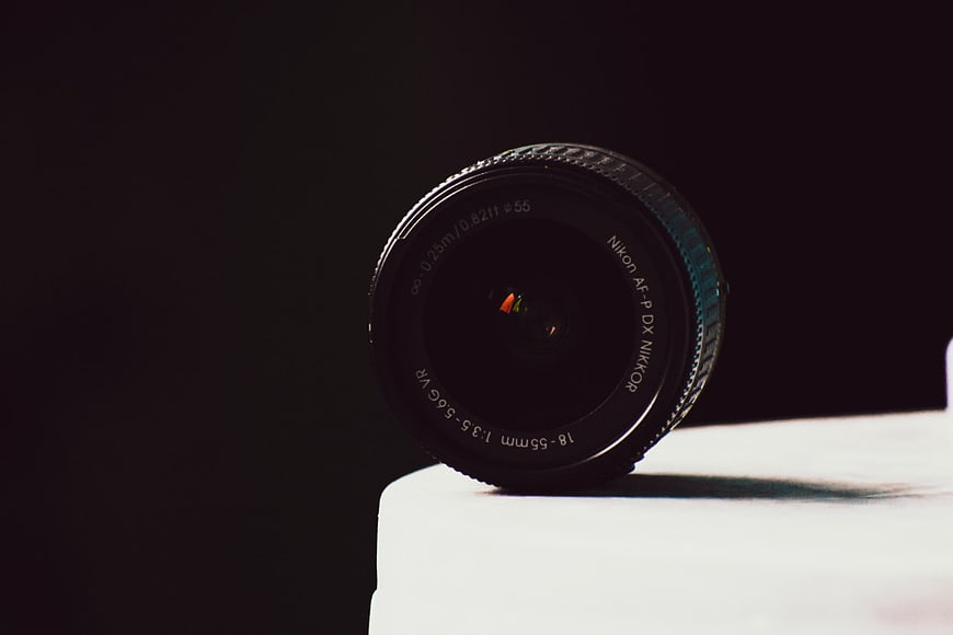 Black Camera Lens on White Surface