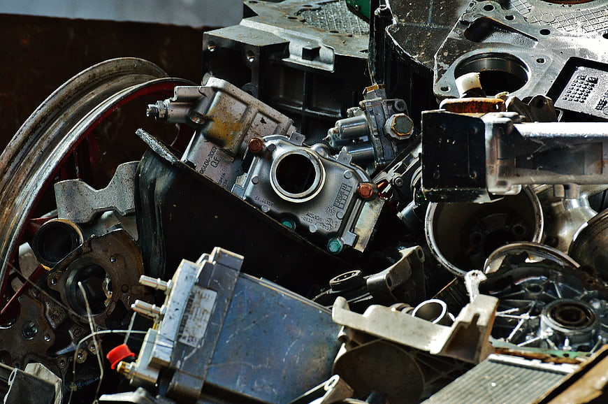 Pile of scrap metal car parts and engine components