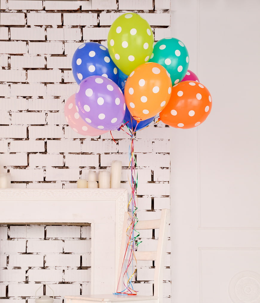 Colorful Polka Dot Balloons on White Brick Wall
