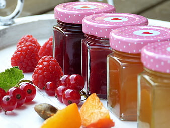 Homemade Raspberry and Apricot Jam Jars With Fresh Berries