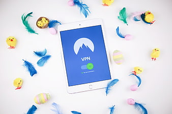 Tablet with VPN app surrounded by Easter eggs and chicks