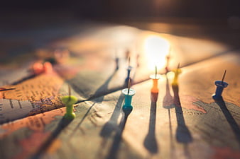 Colorful Push Pins on World Map with Golden Hour Light