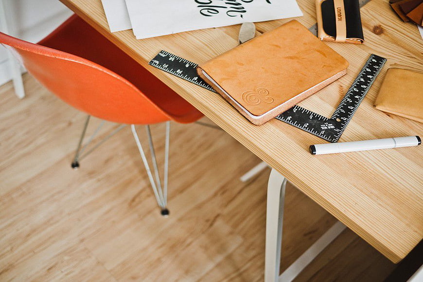 Leather Notebook and Ruler on Wooden Desk