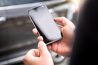 Close-up of hands holding smartphone with blank screen