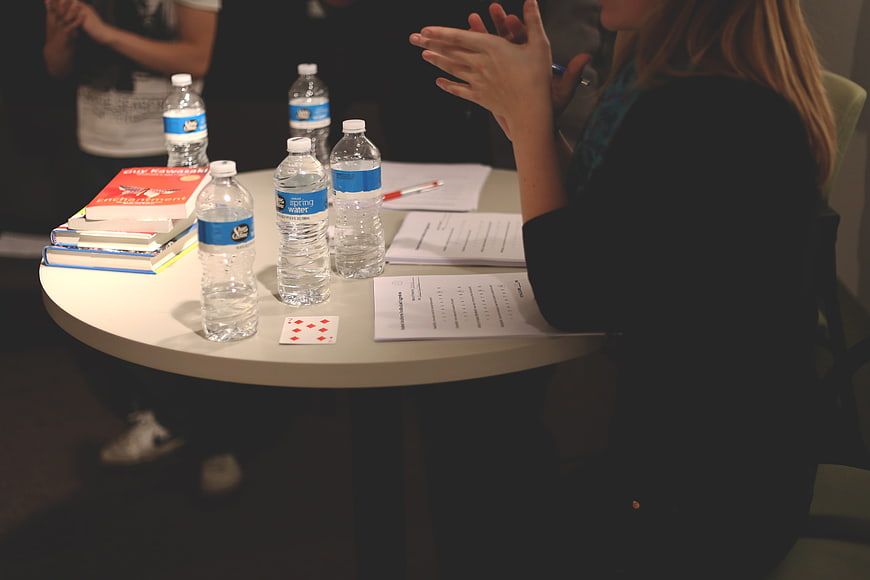 Business meeting with water bottles and books on table