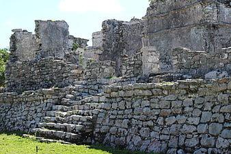 Ancient Mayan stone ruins with steps and walls