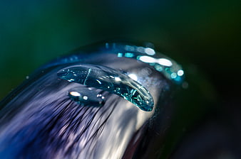 Macro water droplet on metallic faucet surface