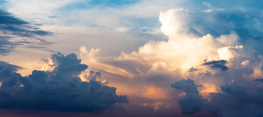 Dramatic Sunset Sky with Golden Sunbeams Through Clouds