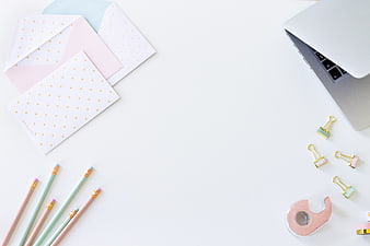 Minimalist pastel workspace flat lay with laptop and stationery