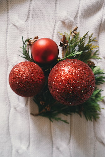 Red Christmas Ornaments on White Knitted Background